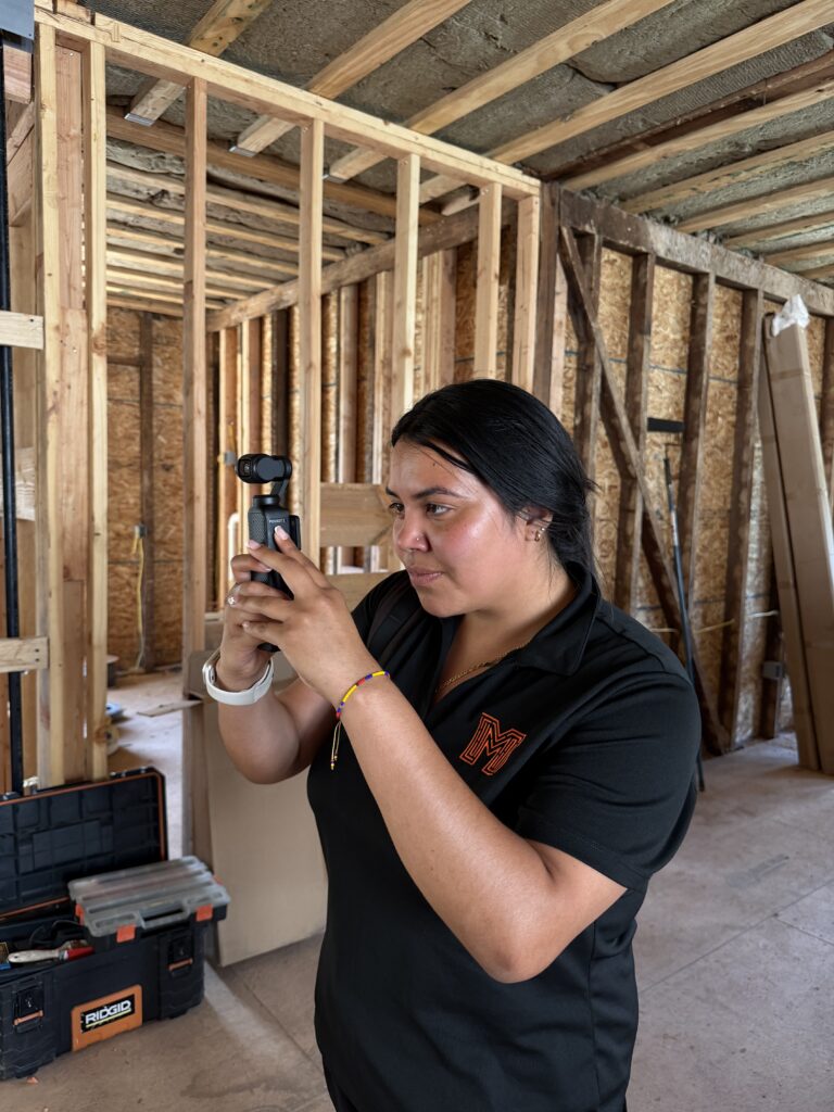 Maze team member filming construction progress content