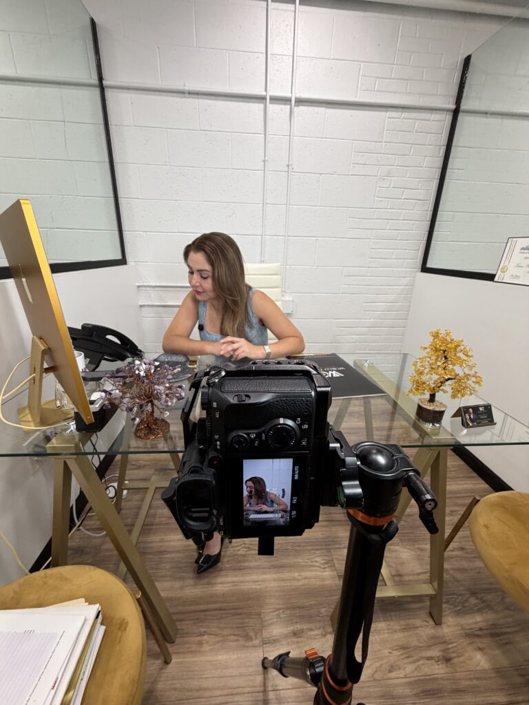 Maze filming a client interview at her desk